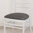 White chair with gray cushion on a plain background.