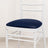 White chair with blue cushion on a plain background.