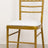 Gold chiavari chair with white cushion on a plain background