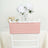 Pink chair cover on a white chair with flowers in the background.