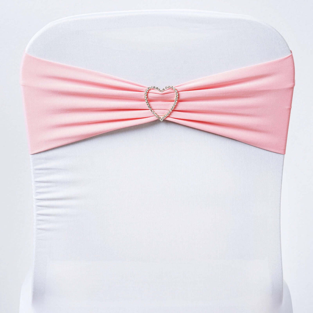 Pink chair cover sash with heart-shaped rhinestone detail