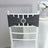 Gray chair sash with rhinestone circle, elegantly draped on a white chair.