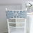 Grey chair sash with rhinestone ring on a white chiavari chair.