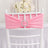 Pink chair sash with rhinestone buckle, elegantly draped on a white chiavari chair.