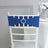 Blue chair sash with jeweled buckle on a white chair.