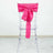 Clear ghost chair with a pink satin bow tied at the back.