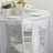 White chair with elegant ribbon bow at a decorated dining table.