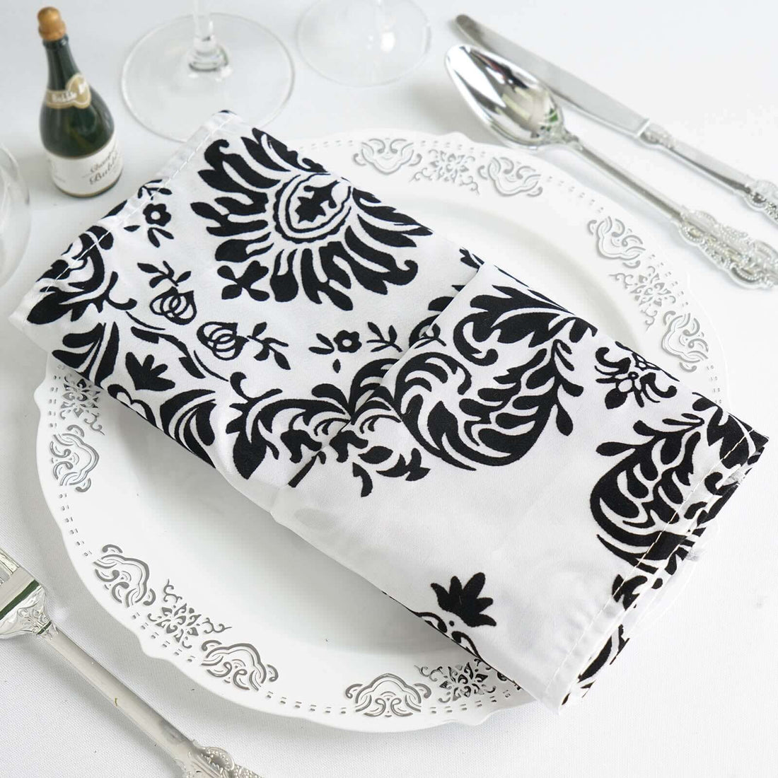 Black and white patterned napkin on a decorative plate. #whtbkgd 