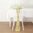 Gold sequin table runner draped over a white chair in a dining setting.