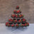 Berry display in a decorative tiered stand with fresh strawberries and mint leaves.