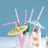 Colorful cocktail umbrellas with straws in a glass.