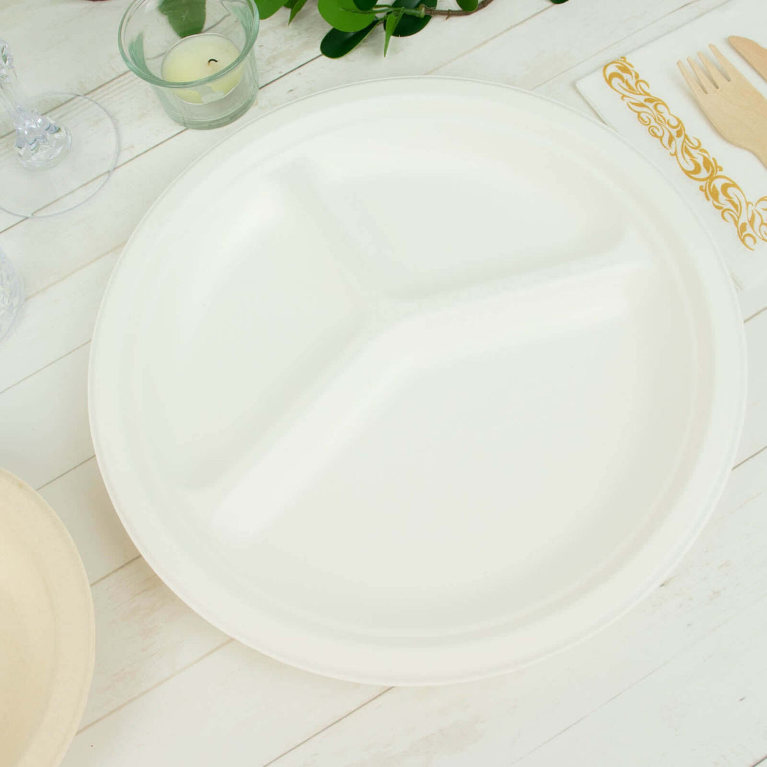 White three-compartment plate on a wooden table with decorative elements.
