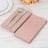 Pink napkins with silver fork and knife on a rustic wooden table.