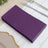 Purple paper napkins stacked on a table setting.