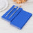 Blue paper napkins stacked with a fork and knife on a wooden table.