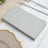 Gray paper napkins stacked on a table setting.