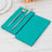 Turquoise napkins with a fork and knife on a wooden table.