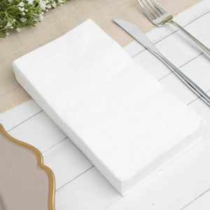 White folded napkin on a table setting with cutlery