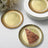 Gold foil dessert plates with a slice of chocolate cake.