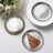 Silver disposable dessert plates with a slice of chocolate cake.
