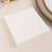 White disposable napkins stacked neatly on a table.