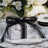 Marble gift box with black ribbon on a decorative table setting.
