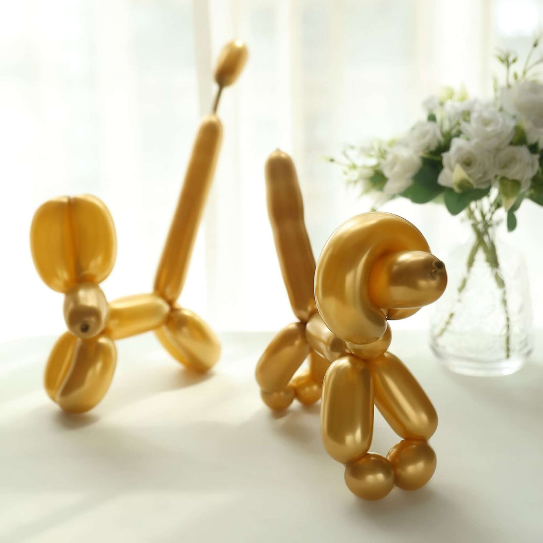 Golden balloon animals in a bright indoor setting.