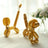 Golden balloon animals in a bright indoor setting.