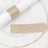 Gold glitter napkin ring and tag on a white plate.