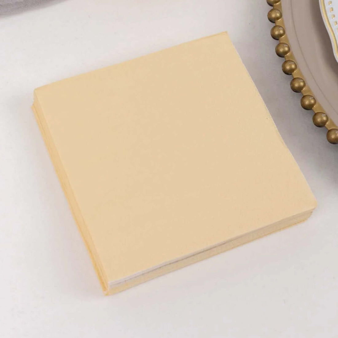 Yellow napkin pack on a table setting.