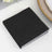 Black napkins stacked on a plain surface for elegant dining.