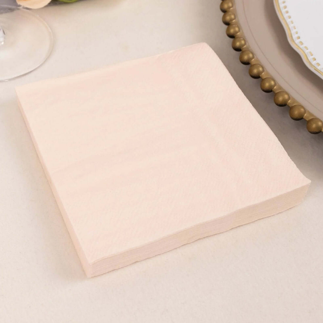 Peach-colored napkin on a neutral background