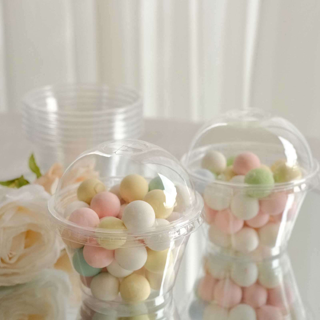 Clear plastic containers filled with colorful decorative balls.