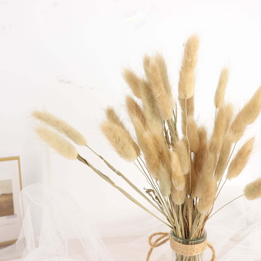 Dried floral arrangement in a glass vase with natural tones