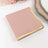 Pink notepad with gold accents on a white backdrop
