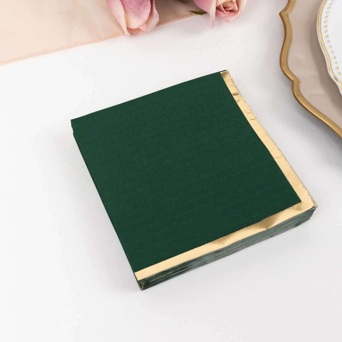 Green napkins with gold edges, perfect for elegant table settings.