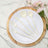 Elegant cream-colored cutlery set on a white plate with a wooden charger.