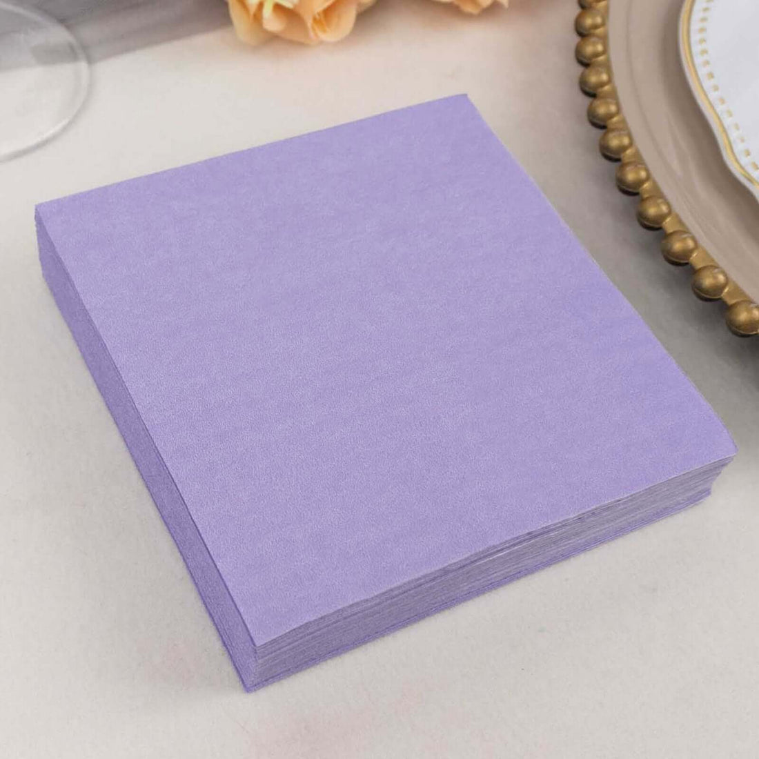 Purple paper napkins stacked neatly for party use