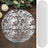 Round textured rug with a distressed white and brown pattern.