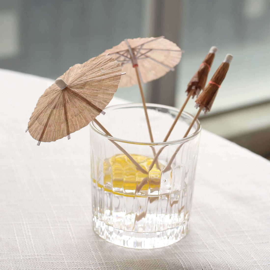 Cocktail glass with decorative paper umbrellas inside