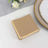 Brown napkin set on a table with elegant dinnerware.