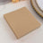 Brown paper napkins stacked neatly on a table.