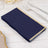 Navy blue napkins with gold trim on a table setting.