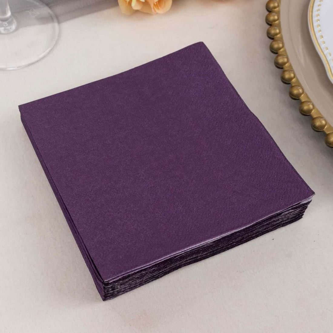 Purple paper napkins stacked on a table.