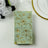 Floral patterned napkin on a table setting with white roses.