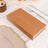 Elegant brown napkin set with gold leaf design on a rustic table setting.