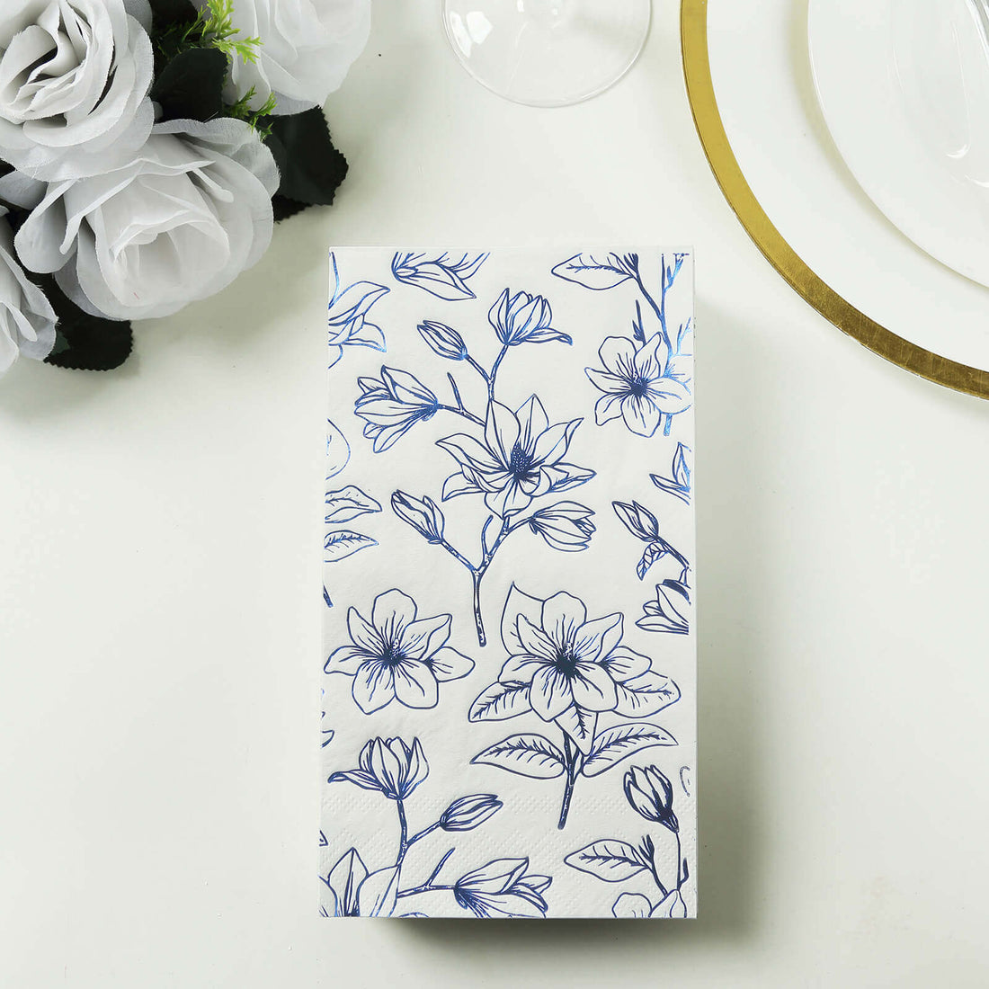 Floral-patterned napkins on a table setting with decorative elements.