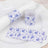 Floral print napkin rings and wrap on a white plate.