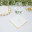 Elegant white coasters with gold trim under a glass of water.
