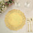Gold lace doily on a dining table with cutlery and floral arrangement.